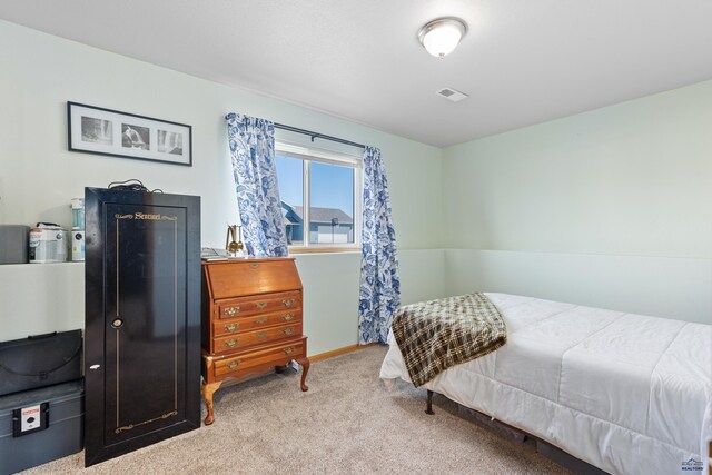 323 Freiheit Ln, Box Elder, SD 57719 - bedroom with baseboards, visible vents, and carpet floors