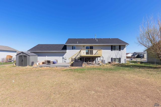 323 Freiheit Ln, Box Elder, SD 57719 - back of property featuring a storage shed, an outbuilding, a deck, fence, and a lawn