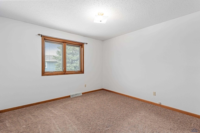 2713 Harney Pl, Rapid City, SD 57702 - empty room with a textured ceiling, baseboards, carpet, and visible vents