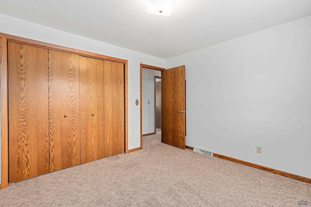 2713 Harney Pl, Rapid City, SD 57702 - unfurnished bedroom with a closet, baseboards, a textured ceiling, visible vents, and carpet