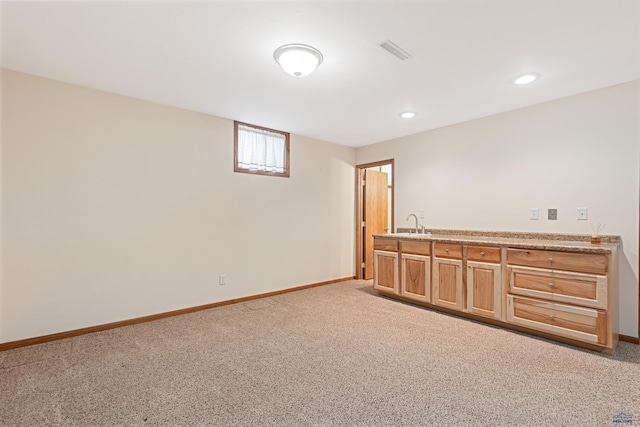 2713 Harney Pl, Rapid City, SD 57702 - interior space featuring visible vents, baseboards, a sink, wet bar, and light colored carpet