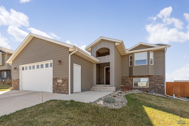 4425 Beringer Dr, Rapid City, SD 57703 - view of front of property with stone siding, concrete driveway, board and batten siding, and an attached garage