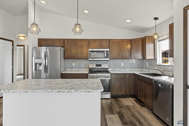 4425 Beringer Dr, Rapid City, SD 57703 - kitchen featuring stainless steel appliances, a sink, lofted ceiling, dark wood-style floors, and light countertops