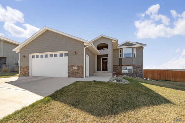 4425 Beringer Dr, Rapid City, SD 57703 - view of front facade with stone siding, concrete driveway, a garage, and board and batten siding