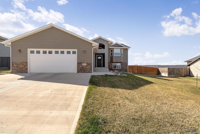 4425 Beringer Dr, Rapid City, SD 57703 - view of front facade featuring stone siding, concrete driveway, and a garage