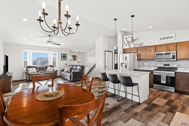 4425 Beringer Dr, Rapid City, SD 57703 - dining space with dark wood-style flooring, a chandelier, recessed lighting, and a ceiling fan