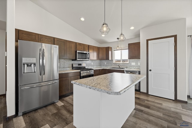 4425 Beringer Dr, Rapid City, SD 57703 - kitchen with appliances with stainless steel finishes, a sink, light countertops, lofted ceiling, and decorative backsplash