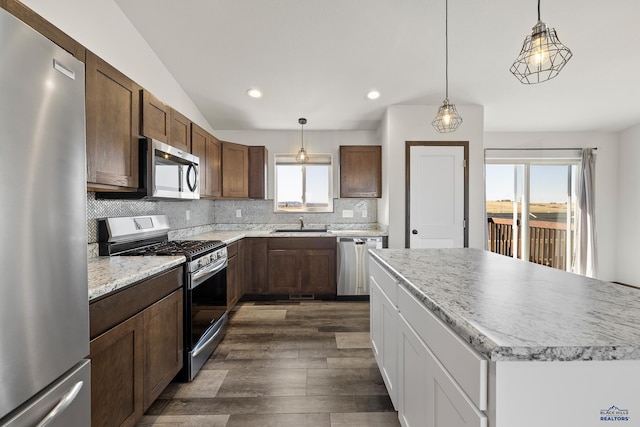4425 Beringer Dr, Rapid City, SD 57703 - kitchen featuring appliances with stainless steel finishes, dark wood-style flooring, decorative backsplash, recessed lighting, and light countertops