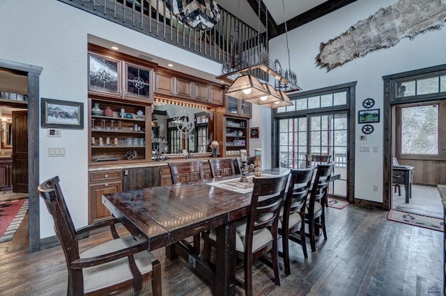 101/109 Sherman St, Rapid City, SD 57702 - dining space featuring dark wood finished floors, a high ceiling, and baseboards