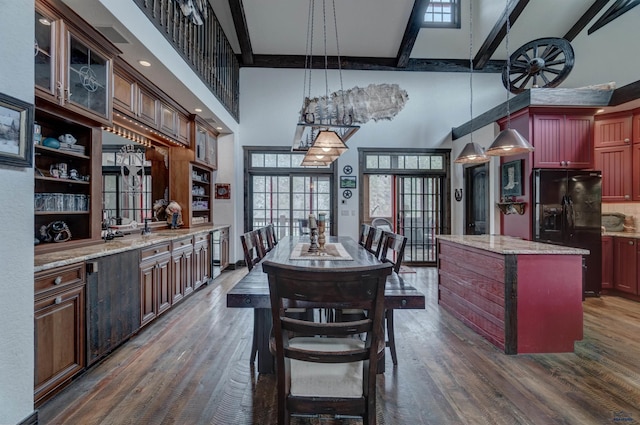 101/109 Sherman St, Rapid City, SD 57702 - dining area featuring a high ceiling, dark wood-style flooring, beamed ceiling, and plenty of natural light