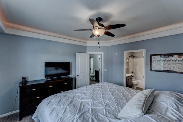 bedroom with carpet, ensuite bath, baseboards, and ceiling fan