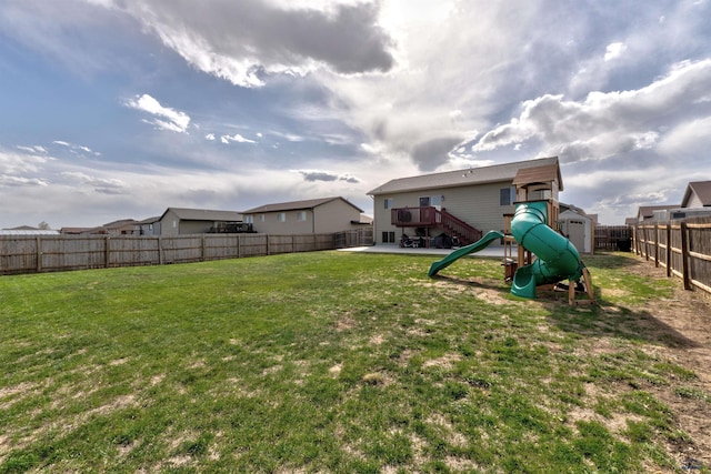 view of yard featuring a fenced backyard and a playground