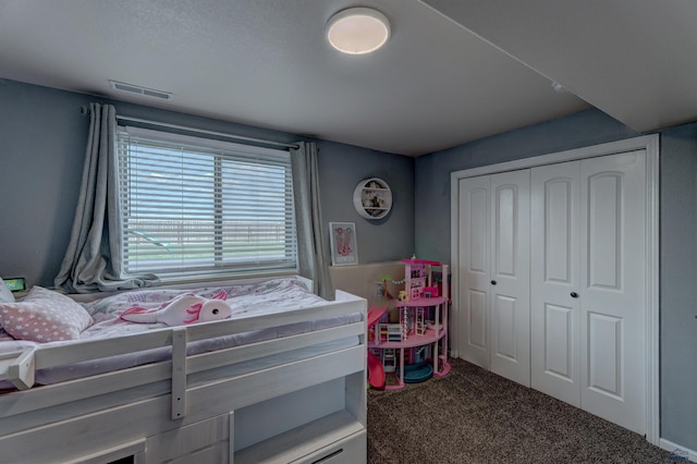 bedroom with visible vents, carpet floors, and a closet