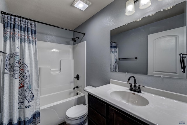full bath featuring a textured wall, vanity, shower / bathtub combination with curtain, and toilet