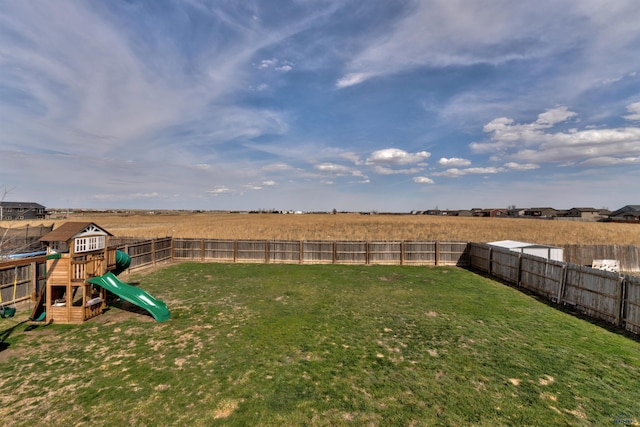 view of yard with a fenced backyard and a playground