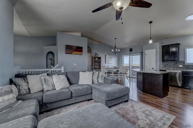 living room featuring dark wood finished floors, lofted ceiling, a healthy amount of sunlight, and ceiling fan with notable chandelier