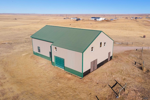 birds eye view of property with a rural view