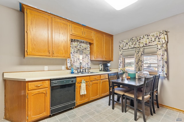 1021 Blaine Ave, Rapid City, SD 57701 - kitchen featuring light countertops, a sink, brown cabinets, and black dishwasher