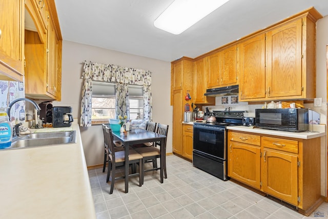 1021 Blaine Ave, Rapid City, SD 57701 - kitchen with black appliances, under cabinet range hood, a sink, and light countertops