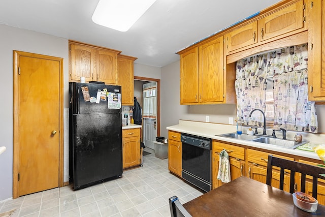 1021 Blaine Ave, Rapid City, SD 57701 - kitchen with light countertops, a sink, brown cabinets, and black appliances
