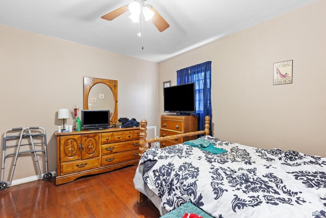 1021 Blaine Ave, Rapid City, SD 57701 - bedroom featuring ceiling fan, baseboards, and dark wood-type flooring