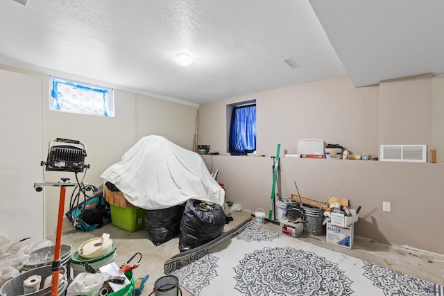 1021 Blaine Ave, Rapid City, SD 57701 - game room featuring visible vents, a textured ceiling, and unfinished concrete floors