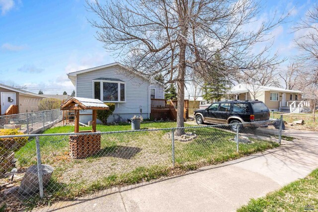 1021 Blaine Ave, Rapid City, SD 57701 - view of front of home with a front lawn and a fenced front yard