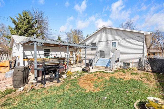 1021 Blaine Ave, Rapid City, SD 57701 - rear view of property with a pergola, a lawn, a hot tub, and fence