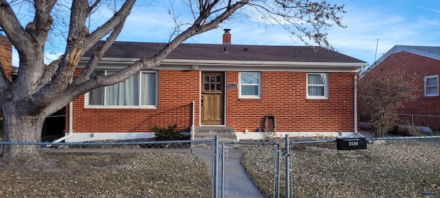2124 Maple Ave, Rapid City, SD 57701 - view of front of property featuring a chimney, a gate, brick siding, and a fenced front yard