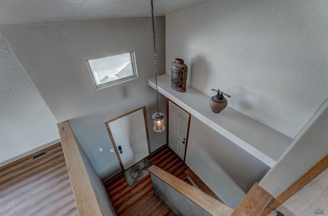 interior space with wood finished floors and visible vents