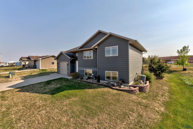 view of front facade with driveway, a front yard, and a garage