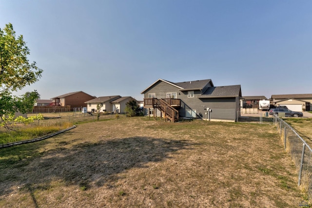view of yard featuring a fenced backyard, stairway, and a deck