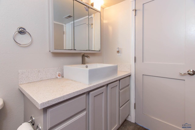 1711 Plateau Ln, Rapid City, SD 57703 - bathroom with visible vents, vanity, and toilet
