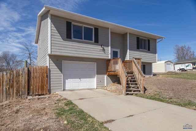 1711 Plateau Ln, Rapid City, SD 57703 - raised ranch featuring an attached garage, fence, and driveway