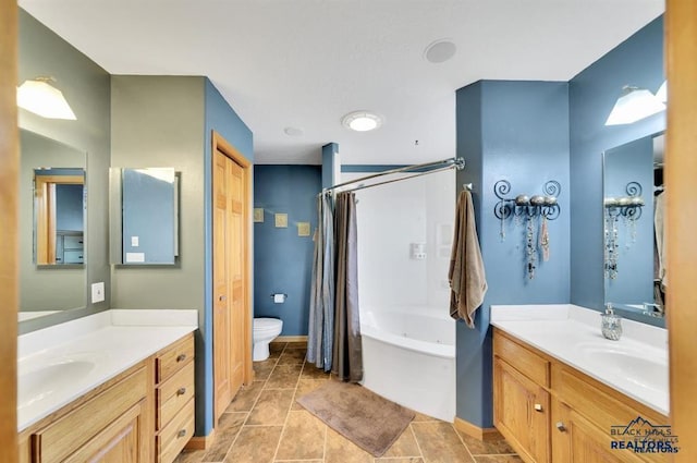 5325 Snowberry Ct, Rapid City, SD 57702 - bathroom featuring two vanities, baseboards, and a sink
