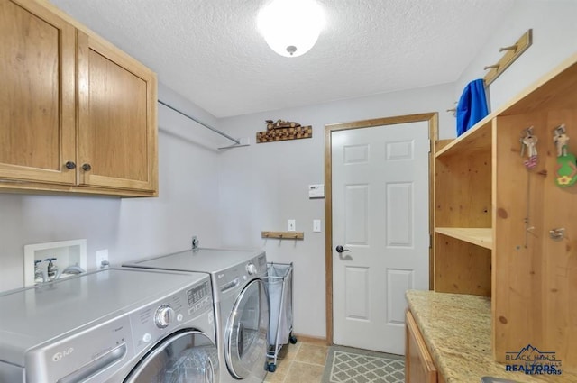 5325 Snowberry Ct, Rapid City, SD 57702 - washroom with light tile patterned floors, independent washer and dryer, baseboards, cabinet space, and a textured ceiling