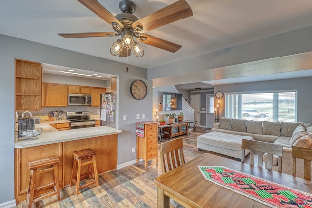 5B Statesboro, Belle Fourche, SD 57717 - living room featuring wood finished floors, baseboards, and ceiling fan