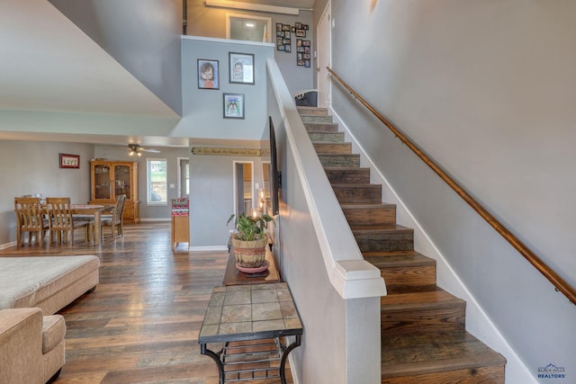 5B Statesboro, Belle Fourche, SD 57717 - stairs featuring baseboards, wood finished floors, a high ceiling, and ceiling fan