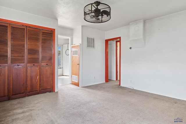 235 E E St, Patrick, Rapid City, SD 57701 - unfurnished bedroom featuring carpet flooring, a closet, ensuite bath, visible vents, and baseboards
