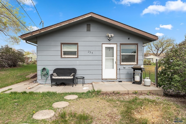 235 E E St, Patrick, Rapid City, SD 57701 - rear view of property with a yard and a patio area