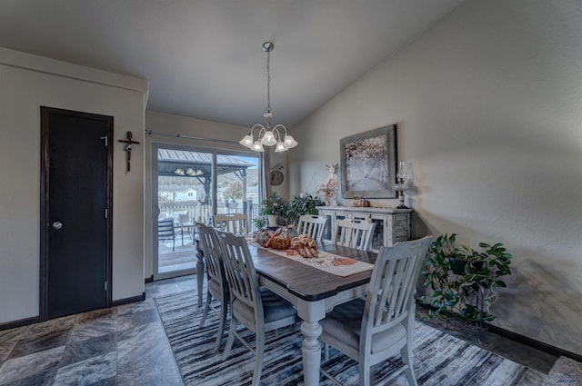 dining area featuring a notable chandelier, vaulted ceiling, and baseboards
