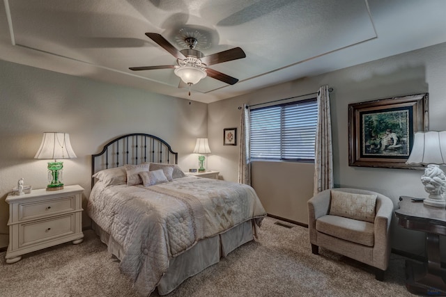 bedroom with visible vents, ceiling fan, and carpet
