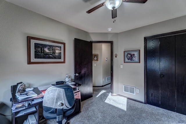 carpeted office space featuring visible vents, ceiling fan, and baseboards