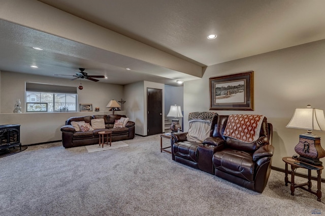 living room featuring recessed lighting, carpet flooring, a wood stove, and baseboards