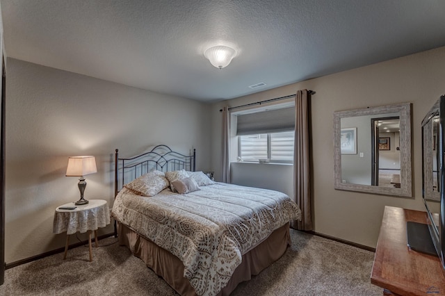 bedroom featuring baseboards, visible vents, carpet floors, and a textured ceiling