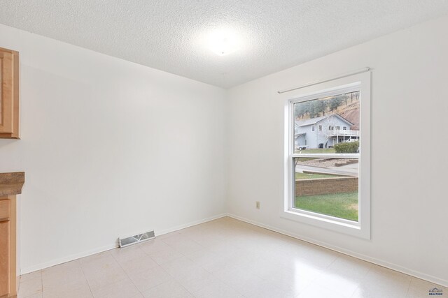 1937 Hillsview Dr, Rapid City, SD 57702 - empty room featuring a textured ceiling, visible vents, and baseboards