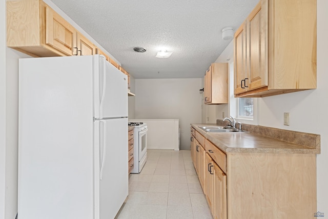 1937 Hillsview Dr, Rapid City, SD 57702 - kitchen with a sink, light tile patterned flooring, light brown cabinetry, white appliances, and a textured ceiling