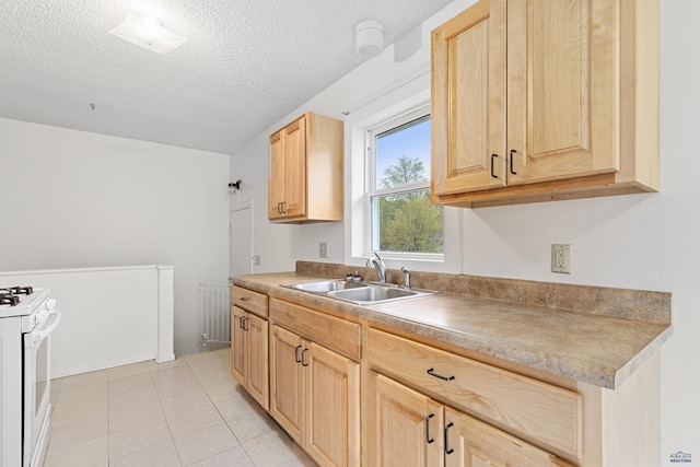 1937 Hillsview Dr, Rapid City, SD 57702 - kitchen featuring radiator, a sink, light brown cabinetry, gas range gas stove, and a textured ceiling