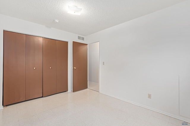 1937 Hillsview Dr, Rapid City, SD 57702 - unfurnished bedroom with a textured ceiling, visible vents, baseboards, a closet, and light floors