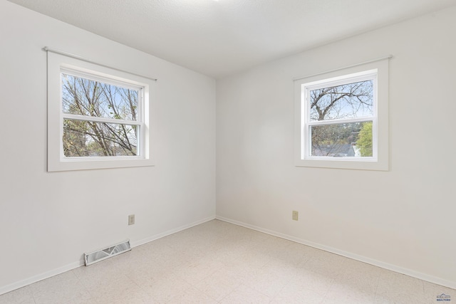 1937 Hillsview Dr, Rapid City, SD 57702 - empty room with visible vents, plenty of natural light, and baseboards